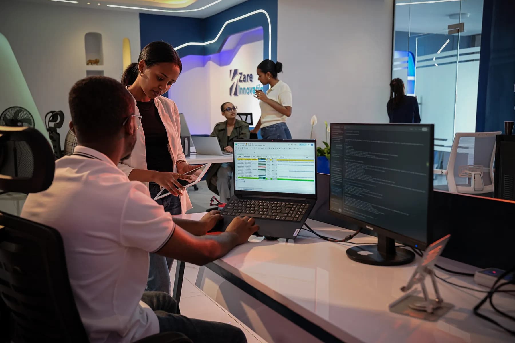 Two Zare engineers reviewing code together at a workstation